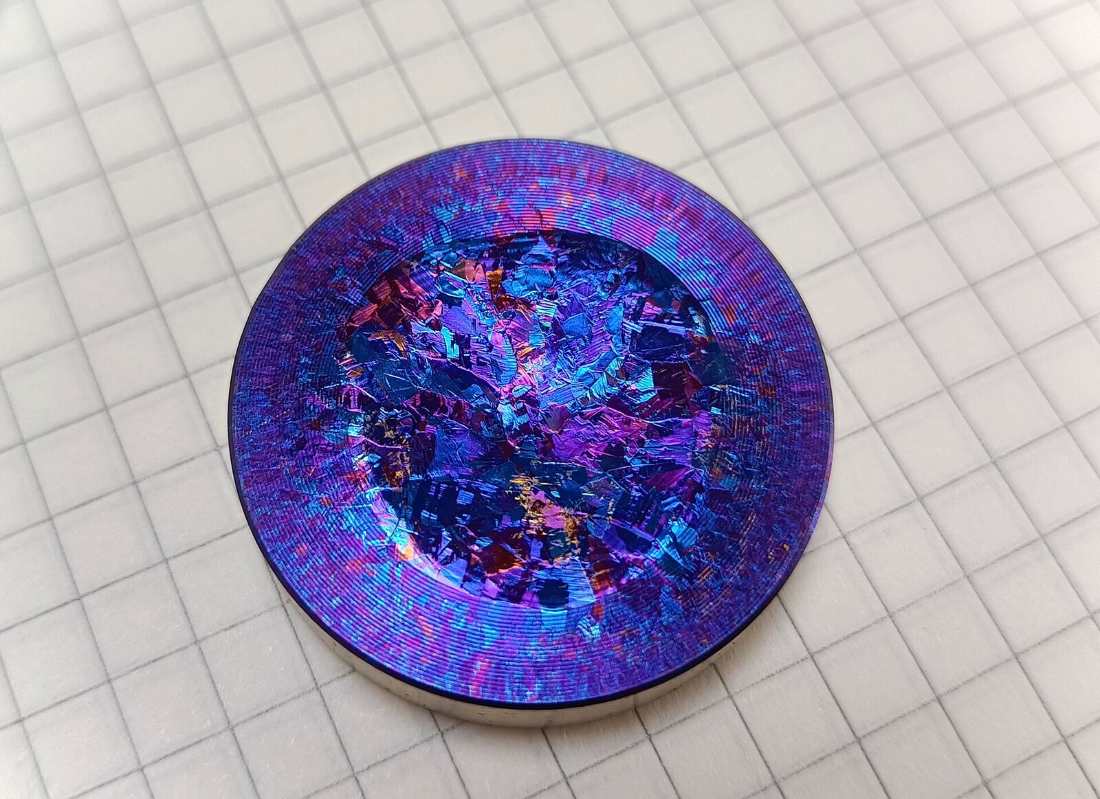 A titanium sputtering target with oxide colours and an erosion track